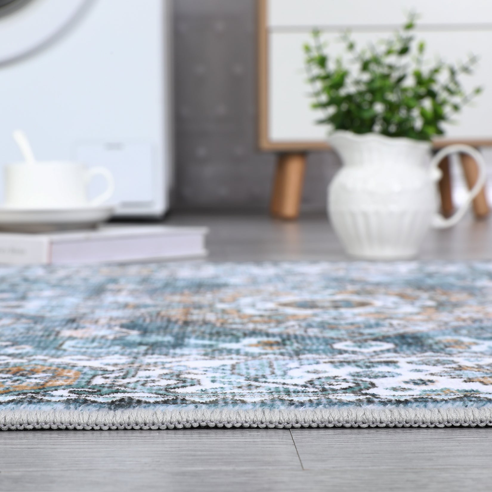 Low pile blue runner rug edge in an indoor kitchen setting