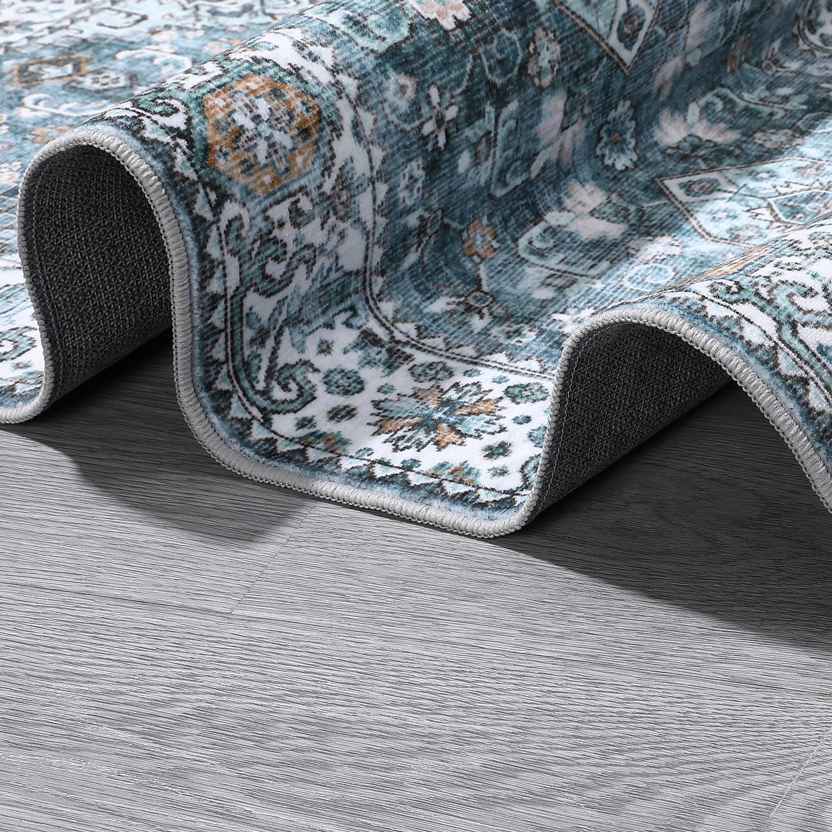 Blue floral area rug detail showing flexible low pile edge