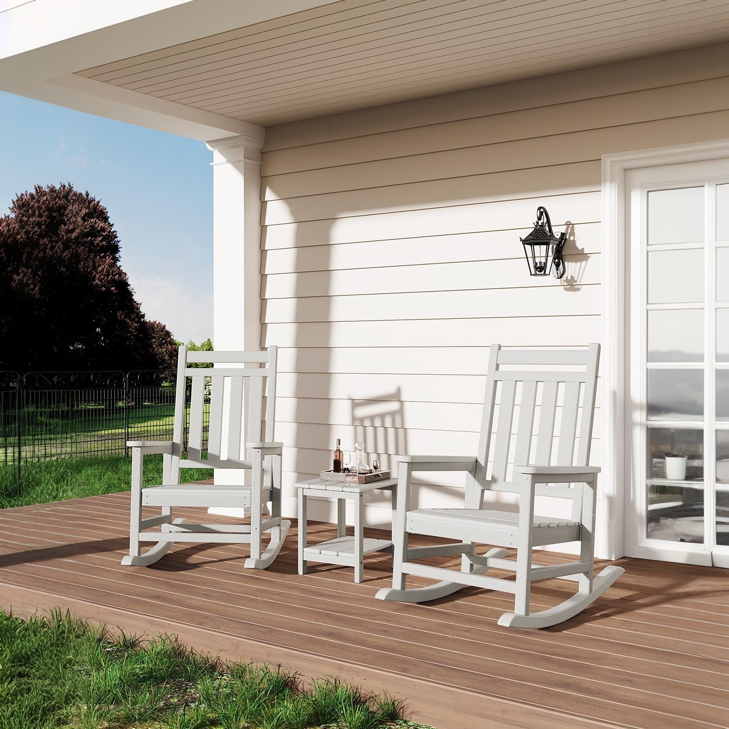 white Adirondack rocking chairs arranged with a side table in an outdoor seating area