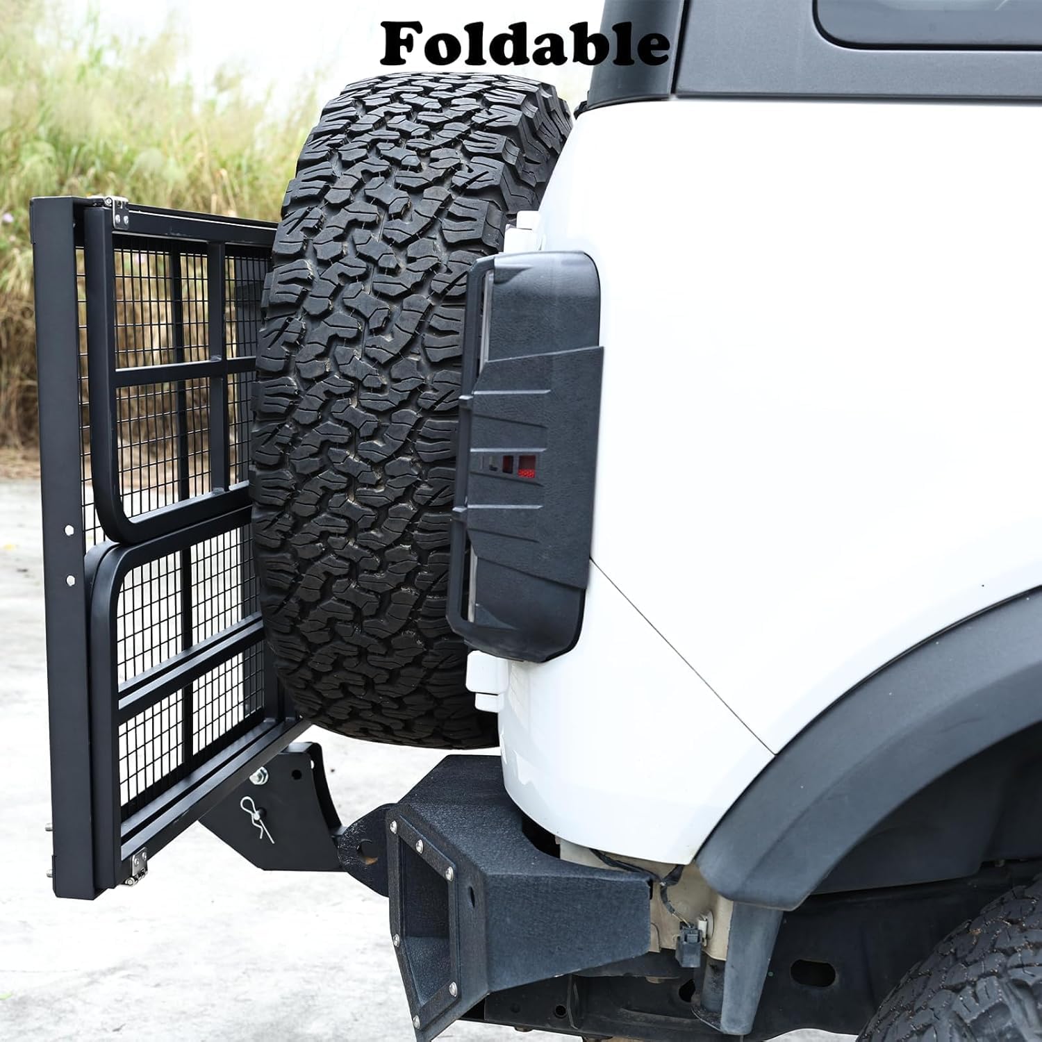 Foldable hitch cargo carrier in upright storage position