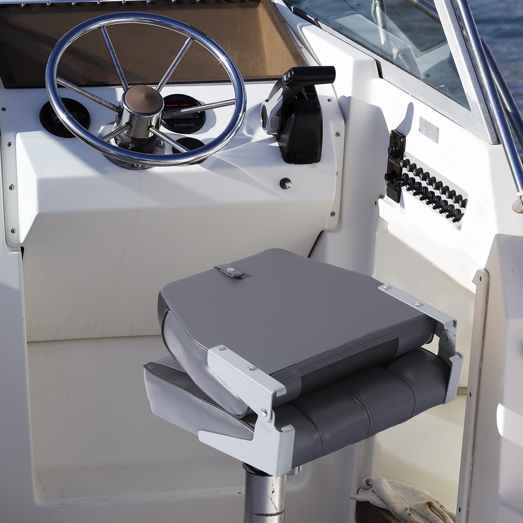 Fold-down boat seat with hold down strap