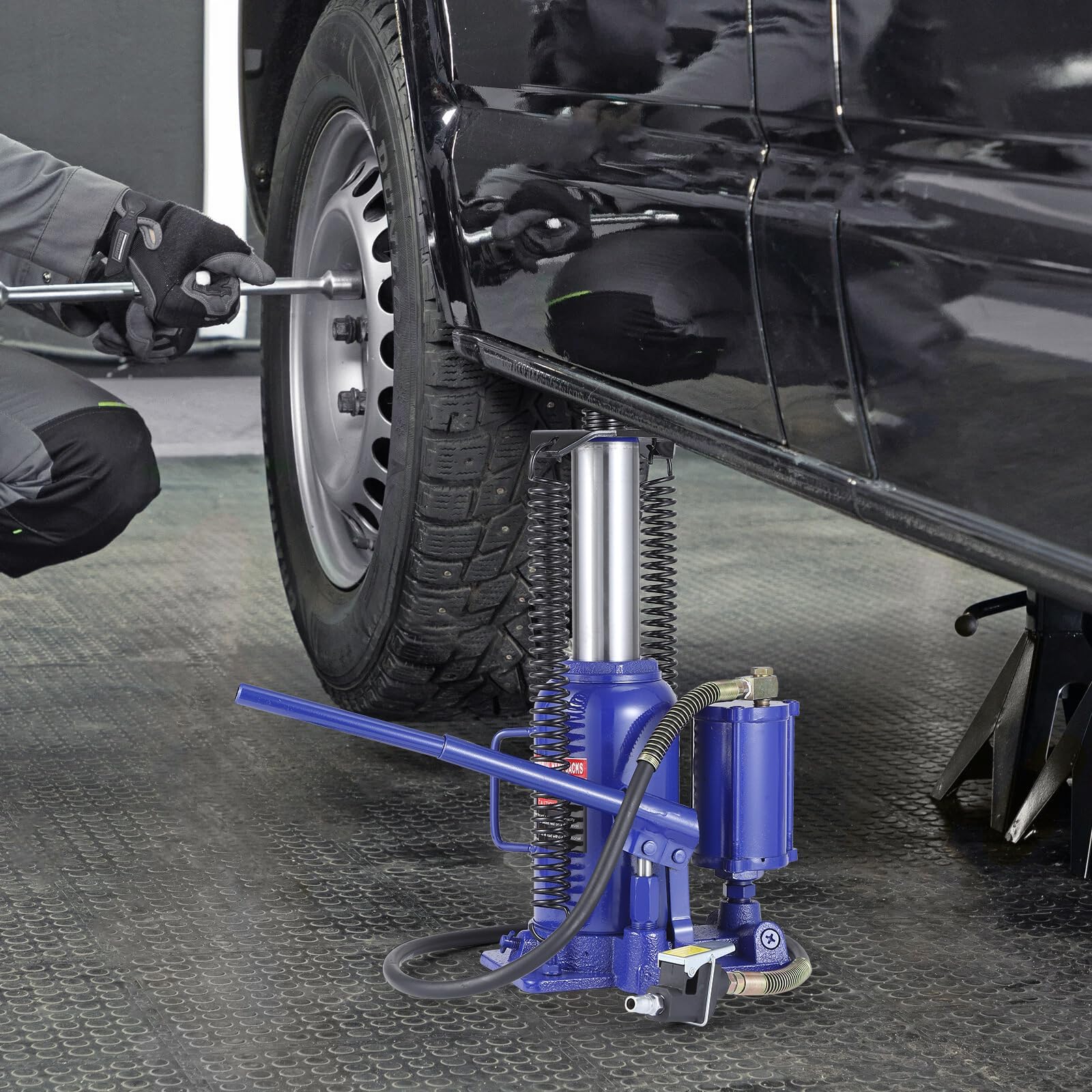 Garvee 22 ton bottle jack lifting a vehicle during repair work
