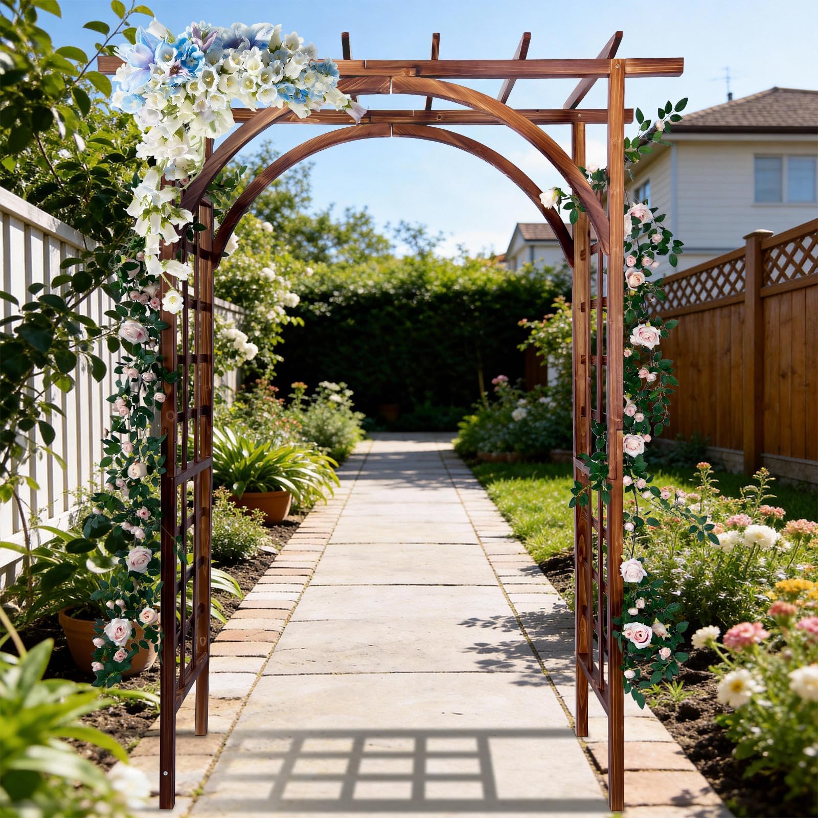 dark brown arched and flat top garden arbor covered with climbing flowers along a garden path