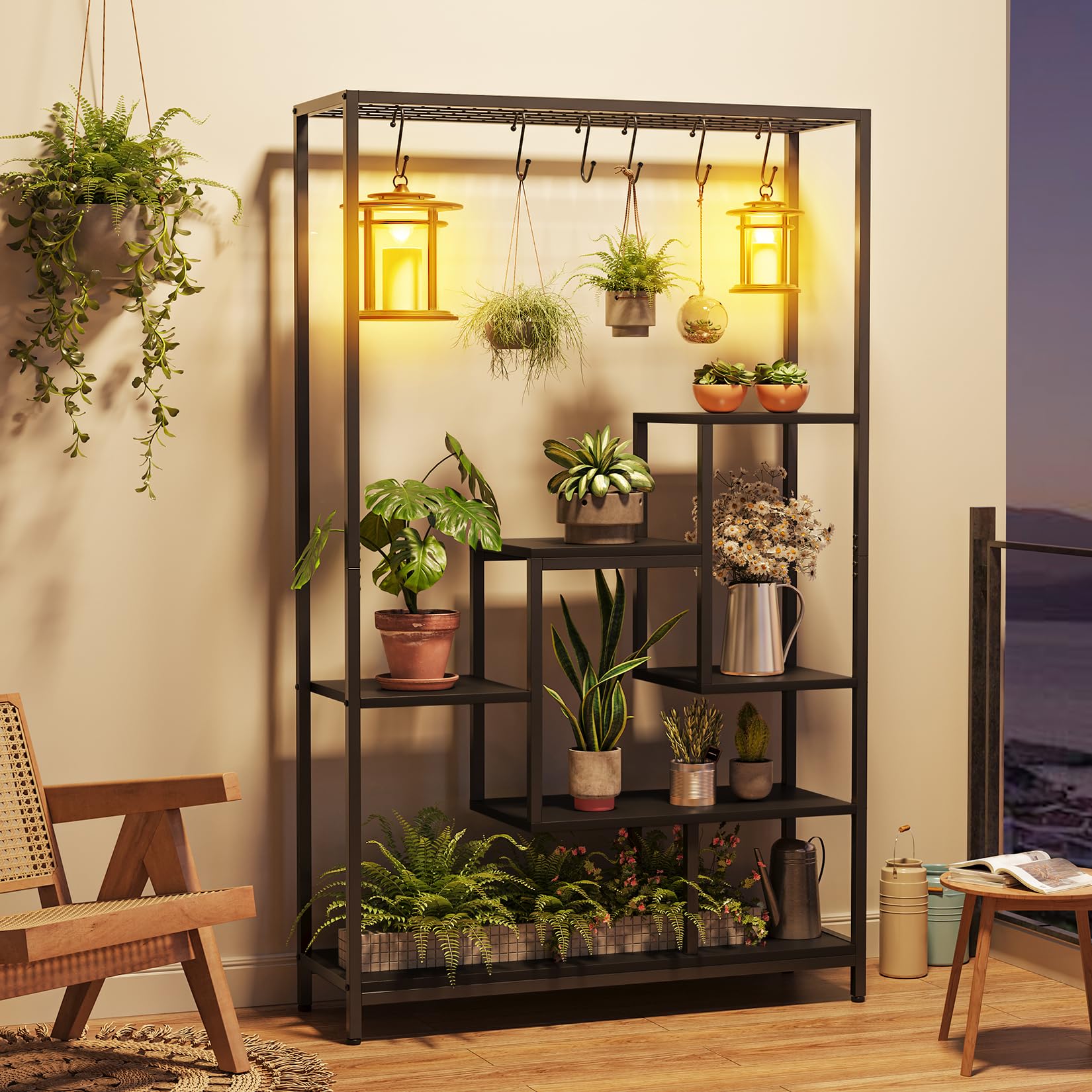Black plant stand with hanging plants and warm room lighting