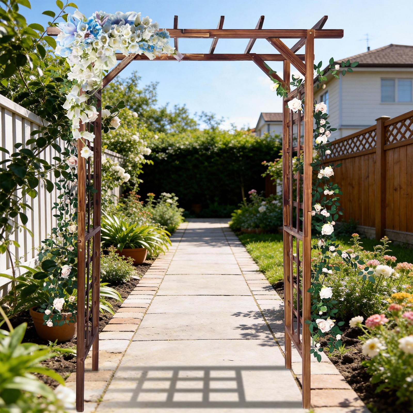 dark brown flat top garden arbor covered with climbing flowers along a landscaped garden path