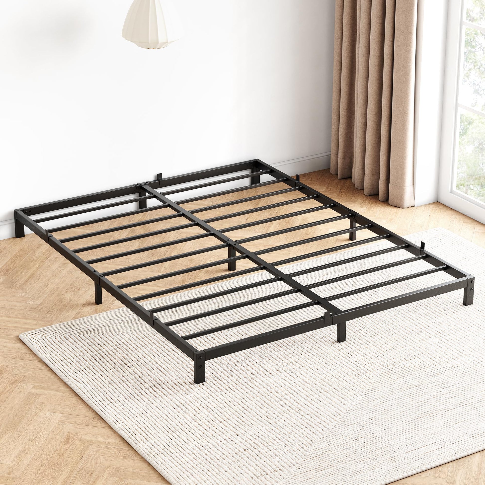 Full bed frame shown during setup with open slat platform