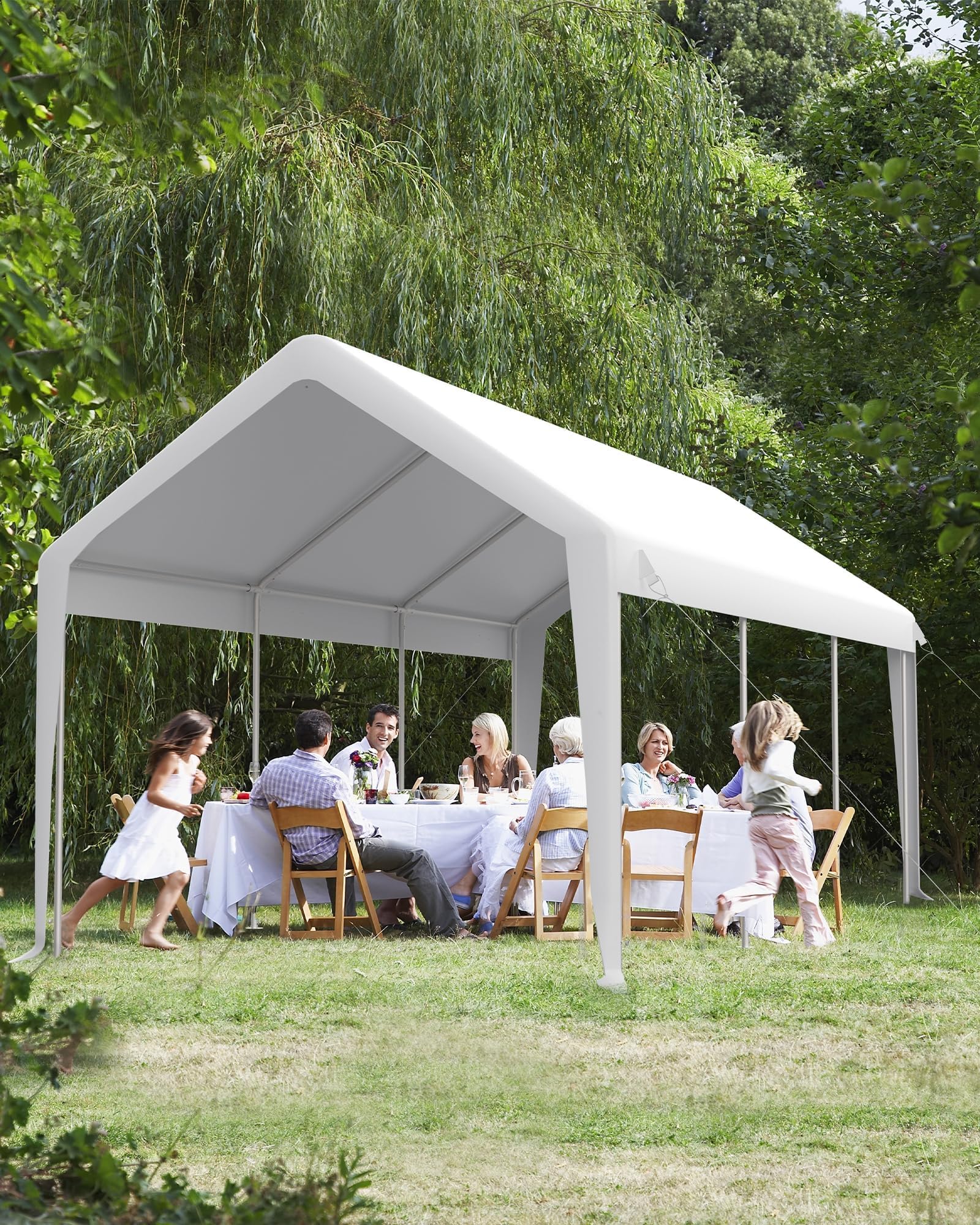 White canopy sheltering an outdoor dining gathering in a grassy yard