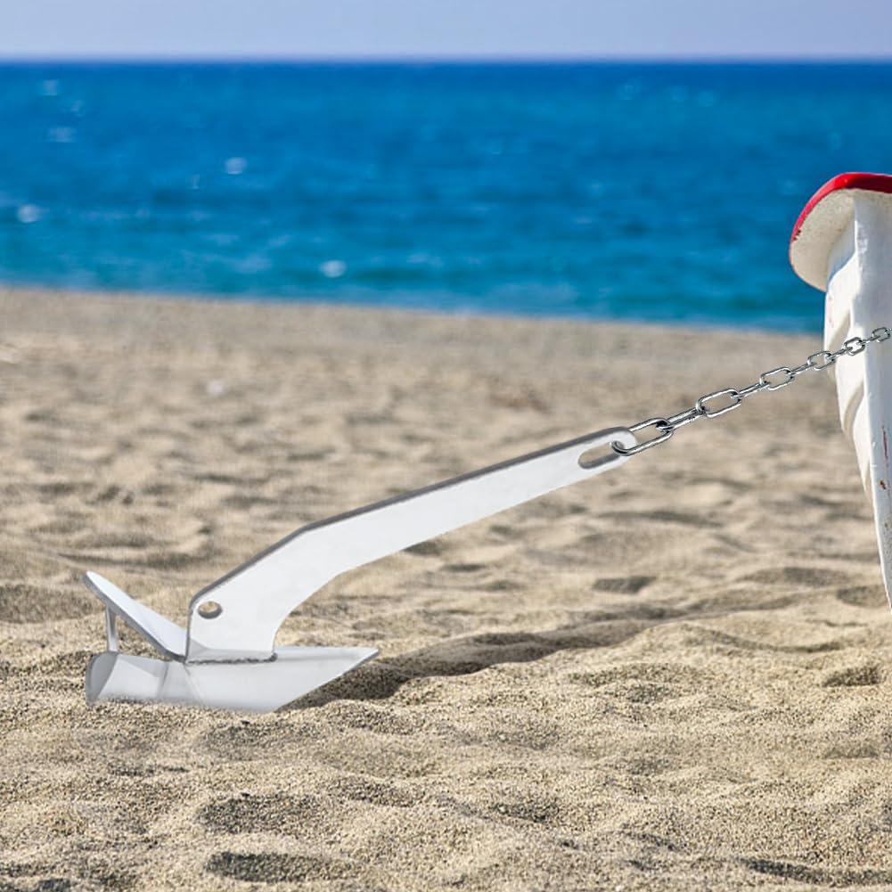 Delta-style boat anchor set in sand near the water