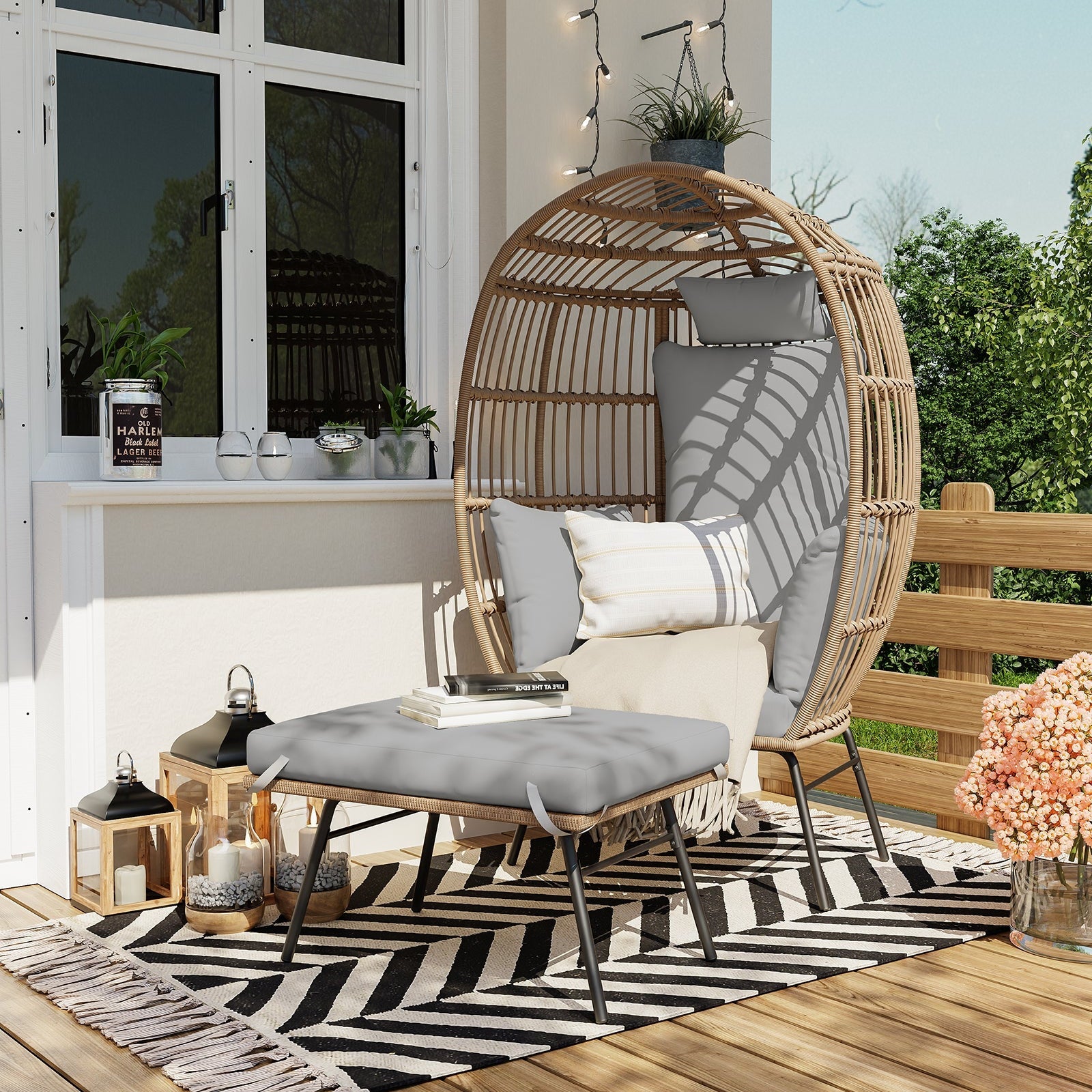 Grey wicker egg chair and ottoman arranged on an outdoor patio
