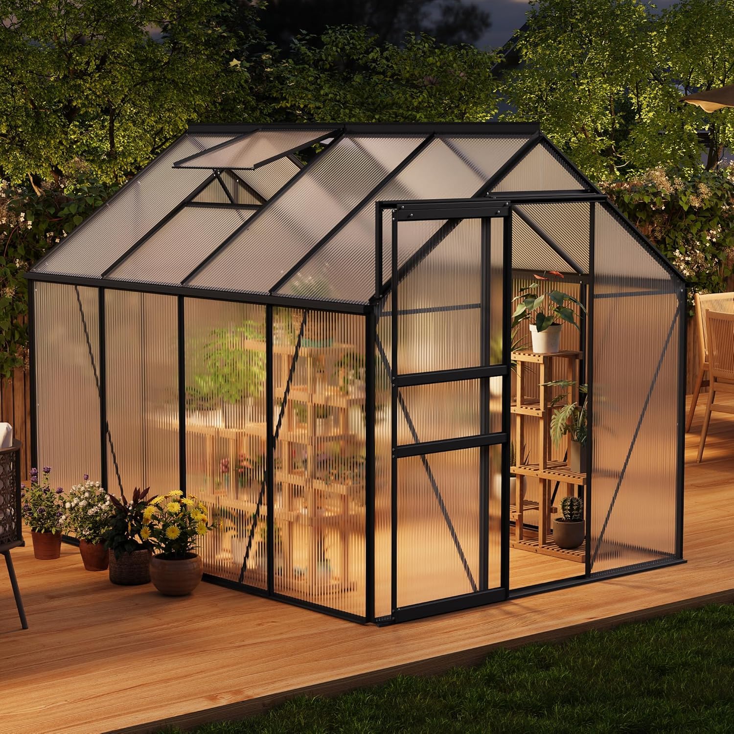 Black polycarbonate greenhouse protecting plants in an evening outdoor setting